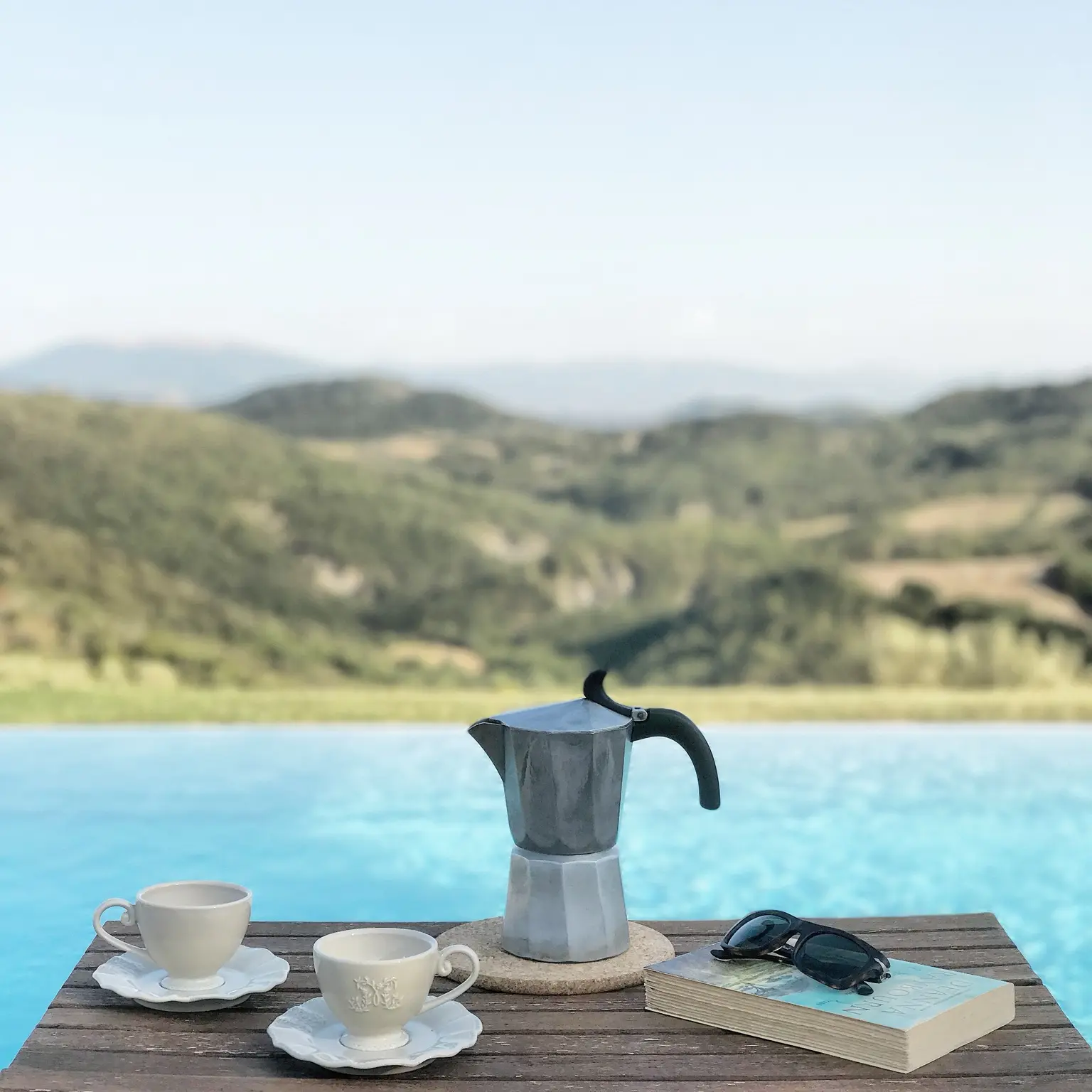 Italian coffee ritual beside a countryside pool