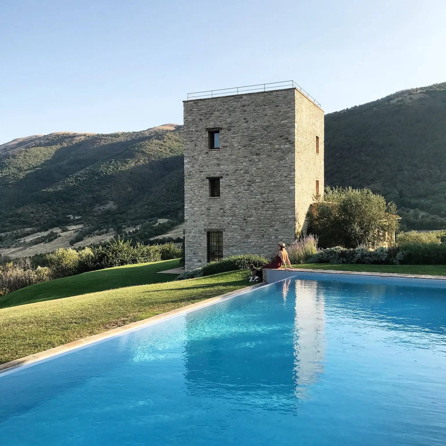 Stone villa and swimming pool framed by the Umbrian landscape
