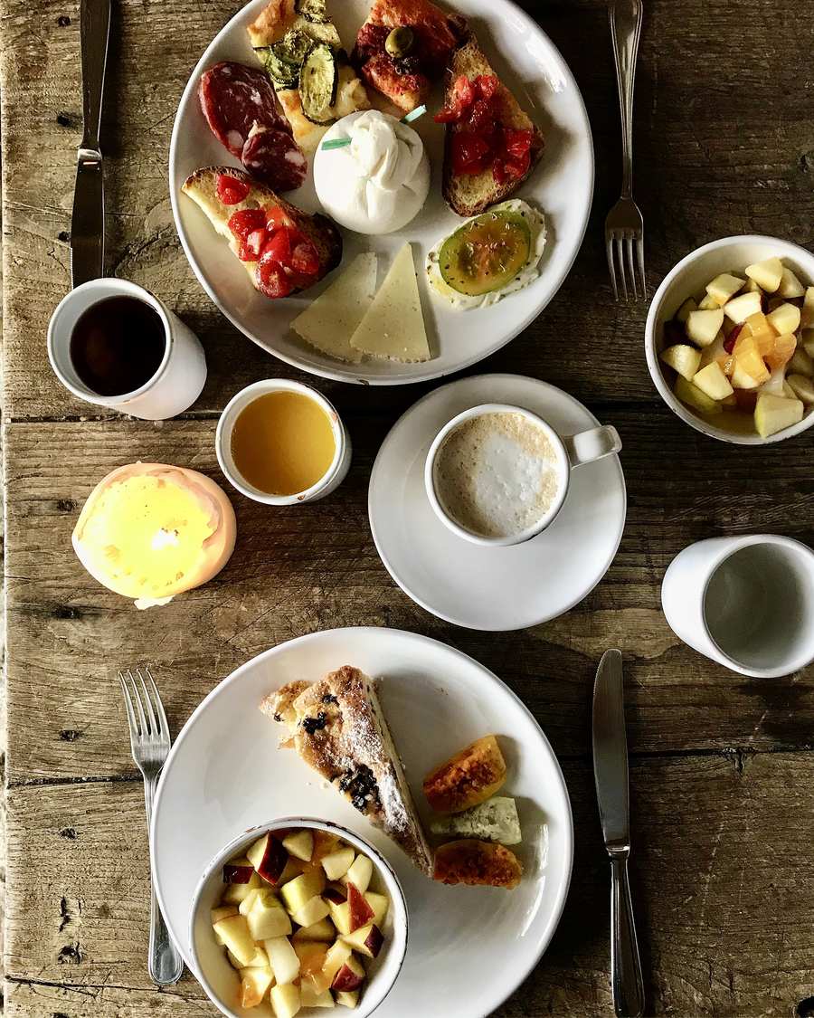 Breakfast with cheese, focaccia, fruit and cakes in Matera