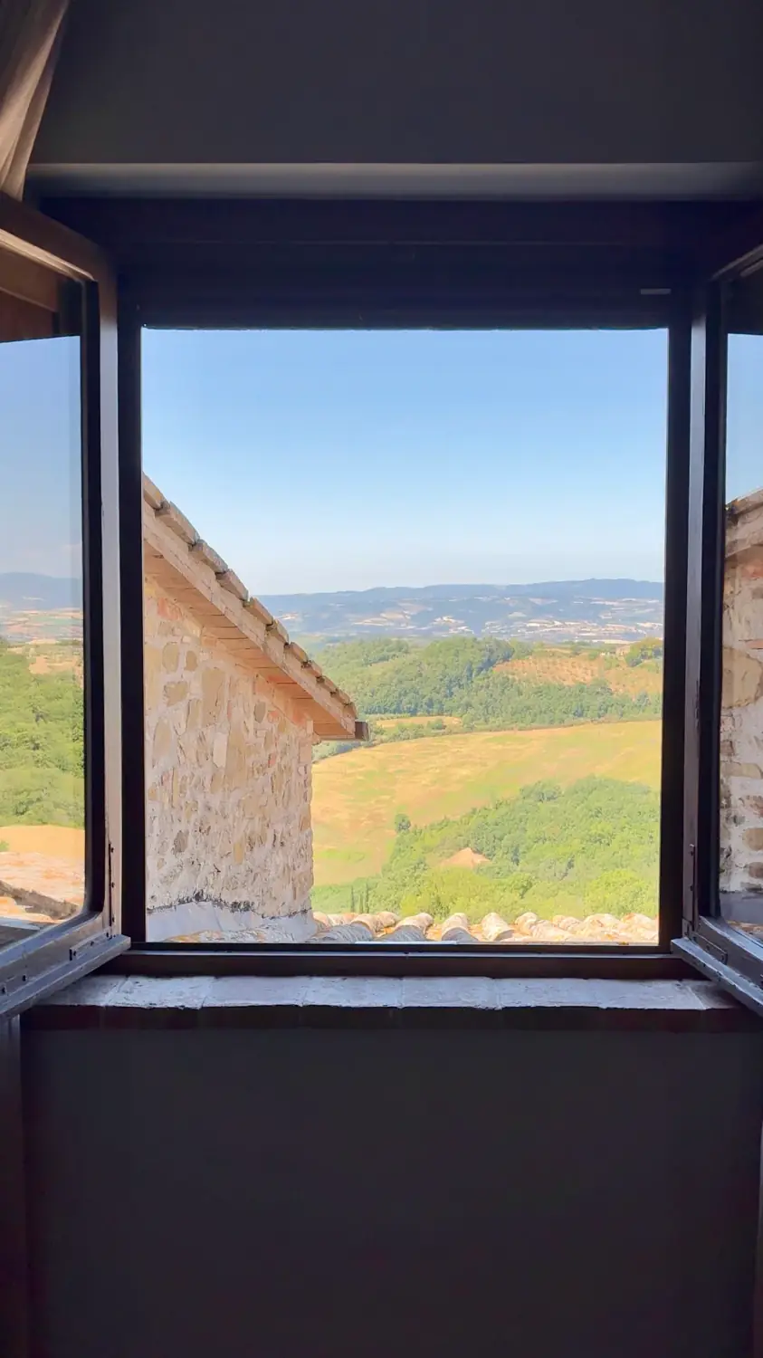 The Umbrian countryside framed by an open window