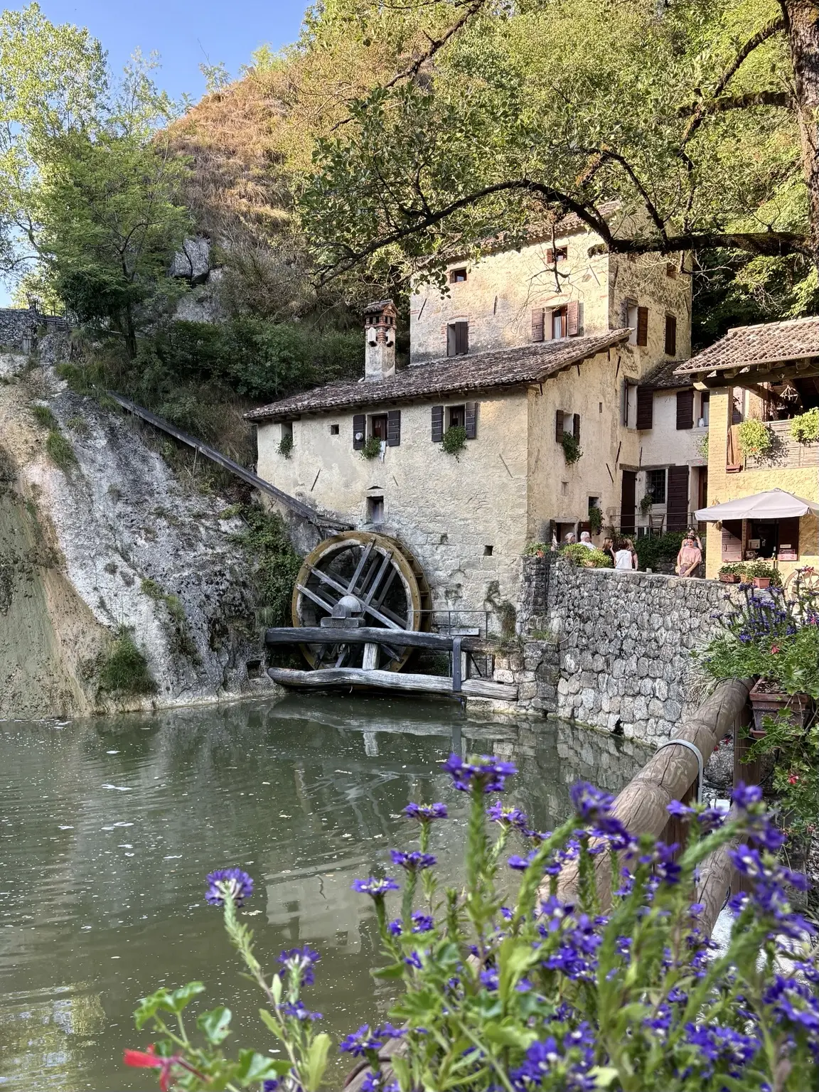 Molinetto della Croda with waterwheel, pond and stone buildings
